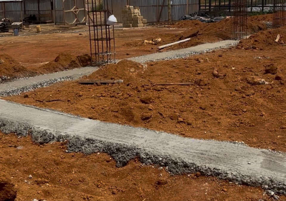Concrete foundation elements and column reinforcement during early building construction