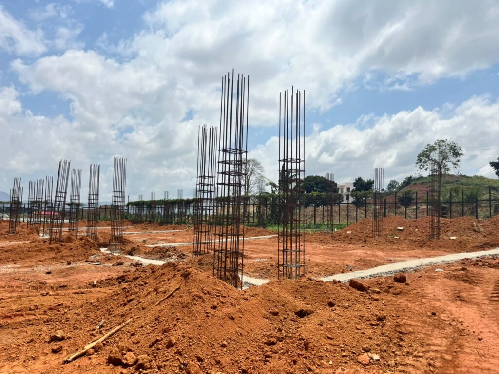 Vertical column reinforcement projecting above foundation works on a construction site